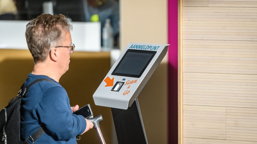Patiënt staat voor een digitale aanmeldbalie